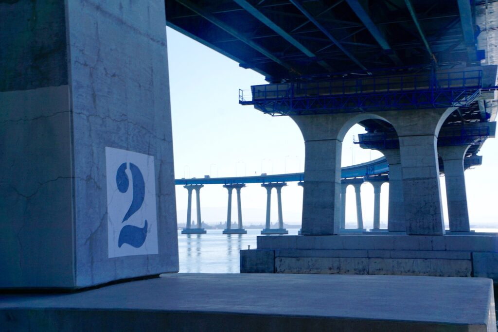 The Bayshore Bikeway passes under the massive San Diego-Coronado Bay Bridge, offering a peek at the bridge from the bottom up. | Photo by Cindy Barks