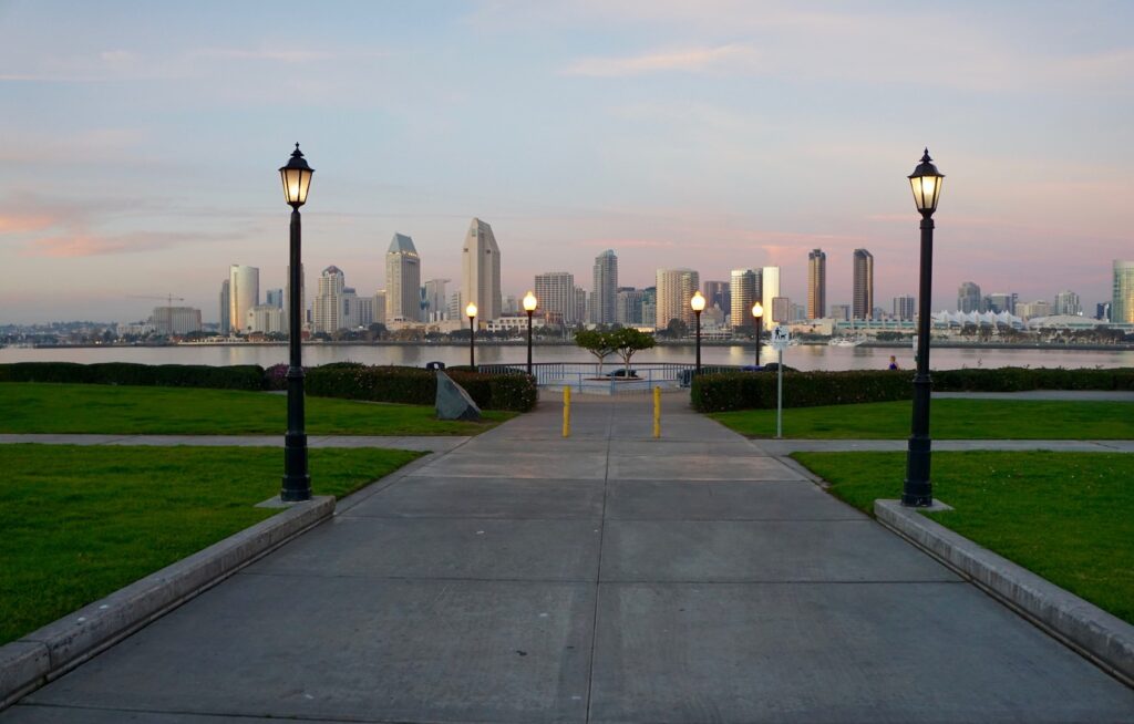 Colorful sunset views of the San Diego skyline and the San Diego-Coronado Bay Bridge are the reward for an evening stroll along the Bayshore Bikeway near the Coronado Ferry Landing. The ferry, which runs from 10 a.m. to 9 p.m., transports sightseers and cyclists between Coronado Island and San Diego. | Photo by Cindy Barks