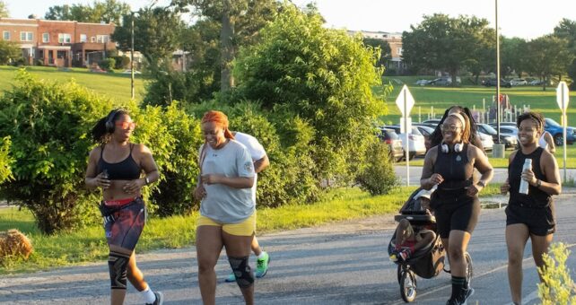 People jogging together on a trail in Baltimore, Maryland | Photo by Allison Abruscato