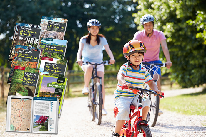 Asian Family On Bicycle Ride In Countryside Wearing Helmet Having Fun