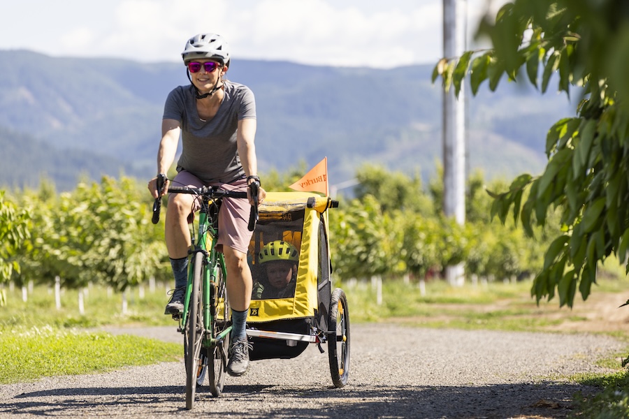 Bicyclist with kid cargo bike | Photo courtesy of Burley