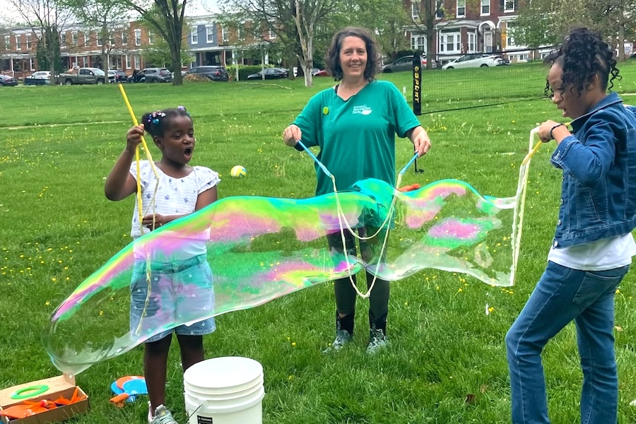 2025 Celebrate Trails Day event with kids and families and bubbles along Herring Run Trail in Baltimore, MD | Photo by Kate Foster