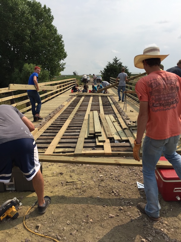 Volunteers build deck bridge west of Gordon in 2019 along the Cowboy Trail West | Photo by Trisha Loosvelt