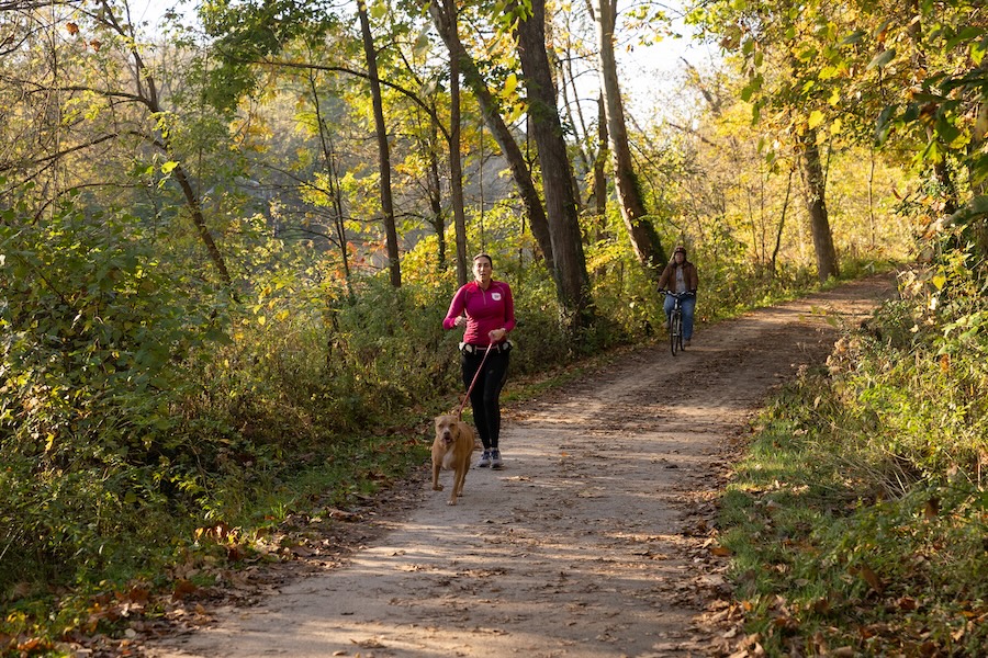 Runner with dog and bicyclist on Ohio & Erie Canal Towpath Trail | Photo by Renee Rosensteel