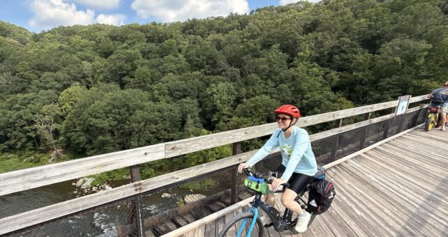 Bicyclist on trestle bridge along the Great Allegheny Passage (GAP, gaptrail.org) | Photo by Ashley Stimpson