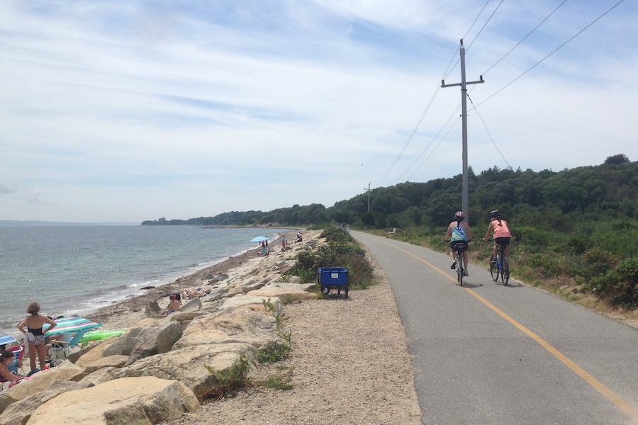 Bicyclists bike along beach on Massachusetts' Shining Sea Bikeway | Photo by Anya Saretzky