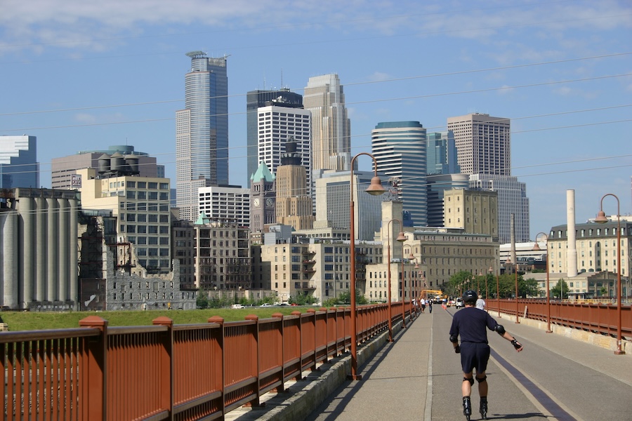 St Anthony Falls Heritage Trail, Minneapolis, Minnesota, MN, Author RTC Unknown, railstotrails.org, Midwest, City, Blue Sky, Clouds, Urban, Urban Infrastructure, Building, People, Fence, Bridge, Back View, Skating, Action, Man, Helmet, Scene On Trail, Horizontal Image, Rail-trail, Cityscape