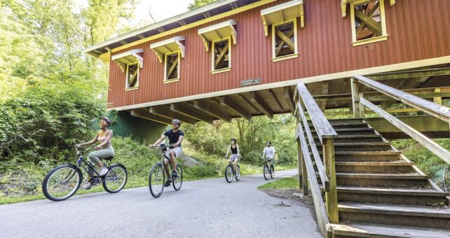 Bicyclists near Richard P. Eastman Hyde Road Covered Bridge along Ohio's Little Miami Scenic Trail | Photo courtesy Greene County Parks and Trails