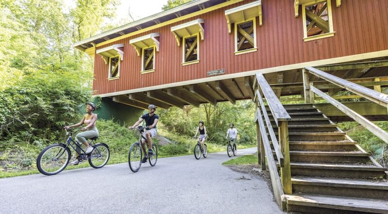 Bicyclists near Richard P. Eastman Hyde Road Covered Bridge along Ohio's Little Miami Scenic Trail | Photo courtesy Greene County Parks and Trails