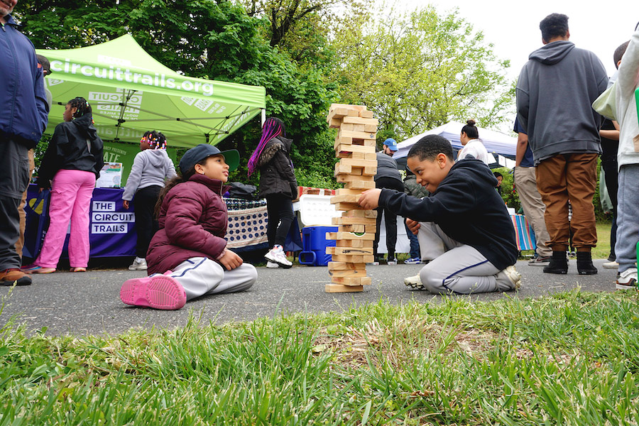 Children enjoying a game of Jenga in New Jersey's Stockton Station Park | Photo by Frank Santos