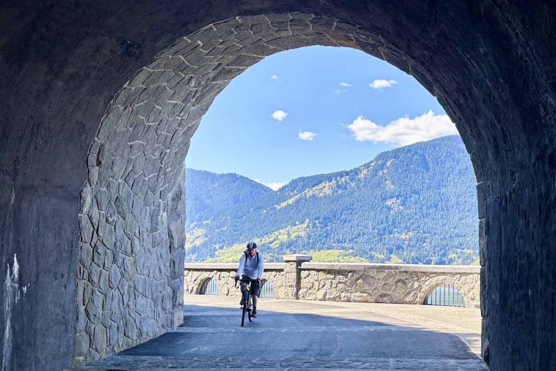 Bicyclist at Mitchell Point Tunnel along Oregon’s Historic Columbia River Highway State Trail | Photo by Glenn Zinkus