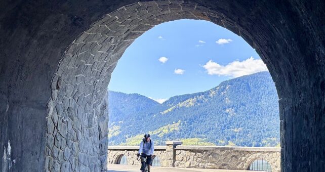 Bicyclist at Mitchell Point Tunnel along Oregon’s Historic Columbia River Highway State Trail | Photo by Glenn Zinkus