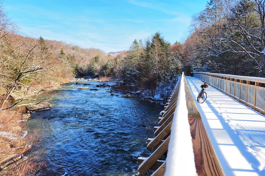 Winter snow on bridge along West Virginia's Meadow River Rail Trail | Photo courtesy Adventure Meadow River