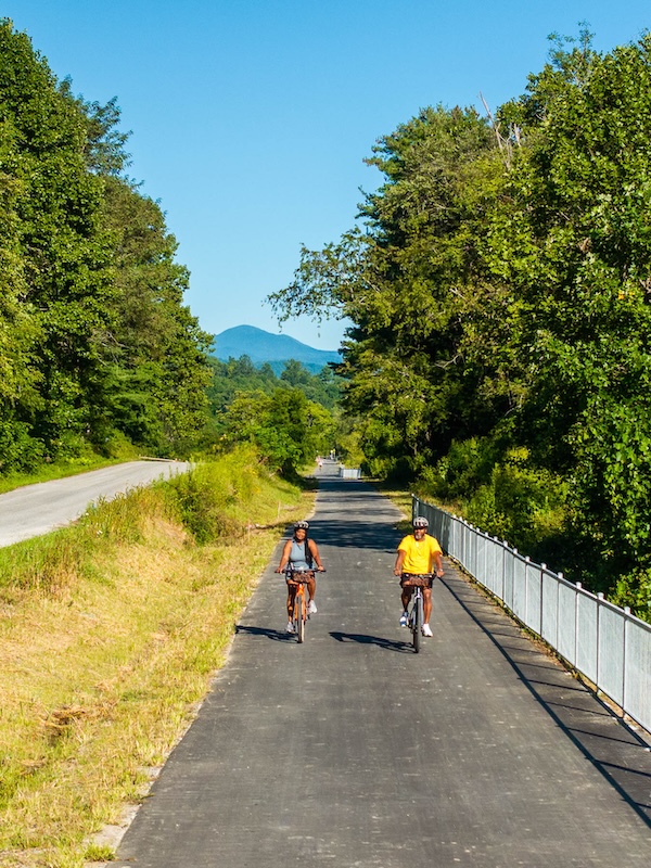 Bicyclists ride the Ecusta Trail in Hendersonville, NC | Photo by Derek DiLuzio, courtesy Visit Hendersonville