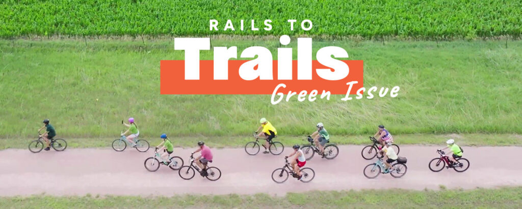 Green Issue cover of bicyclists on Cowboy Trail