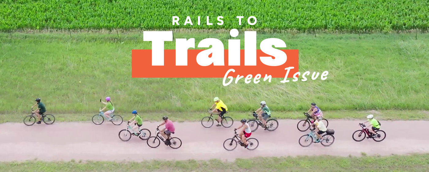 Green Issue cover of bicyclists on Cowboy Trail