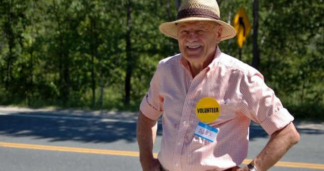 Alex Bernhard manning a Friends of the Northern Rail Trail info table in 2011 | Photo courtesy Lindy Heim, Friends of the Northern Rail Trail