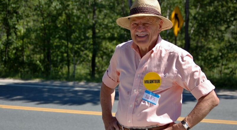 Alex Bernhard manning a Friends of the Northern Rail Trail info table in 2011 | Photo courtesy Lindy Heim, Friends of the Northern Rail Trail