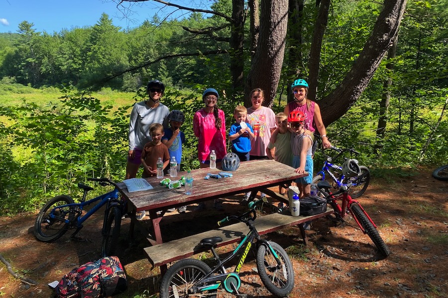 Bicyclists at picnic table | Photo courtesy Friends of the Northern Rail Trail