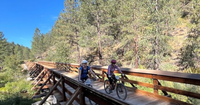 Bicyclists on a bridge along California's Bizz Johnson Trail | Photo by Cindy Barks